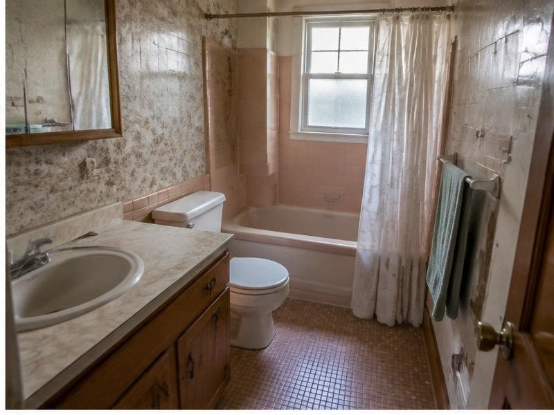 Dated bathroom with a tight layout and limited storage